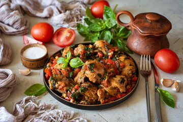A hearty dinner dish: Baked chicken with spices, vegetables and fresh herbs on a beautiful plate.Grilled chicken with vegetables for lunch for the whole family.
