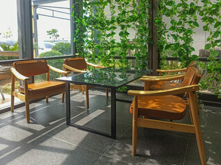 Interior of a modern cafe with wooden chairs and table. Nobody inside