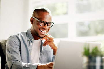 African American businessman working on laptop at office desk
