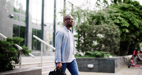Fototapeta premium young businessman walks confidently through the city streets, managing finances