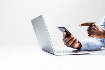 Focused African American man utilizes laptop for work, managing online presence