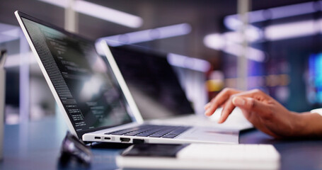 Multi-tasking African American Woman Coding Website on Laptop at Office Desk