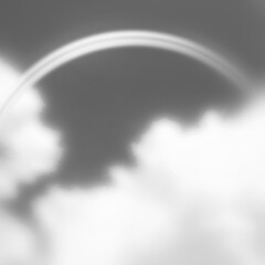モノクロの空に虹と雲
