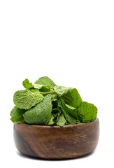 Closeup of Raw Mint Leaves or Pudina Leaves in a Wooden Bowl Isolate on White Background with Copy Space