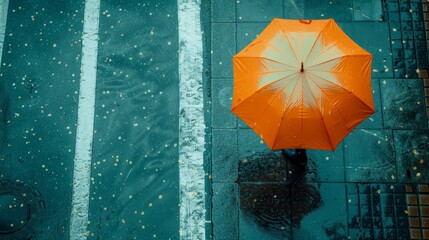 Aerial perspective of an urban street, person holding an orange umbrella during a rainstorm, with a teal environment for visual impact