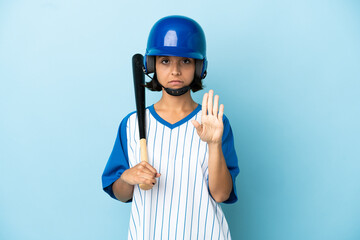 Baseball mixed race player woman with helmet and bat isolated on blue background making stop gesture