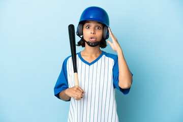 Baseball mixed race player woman with helmet and bat isolated on blue background with surprise expression