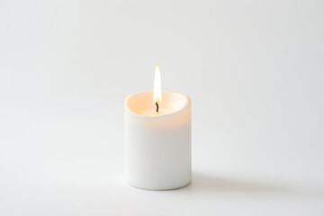 Single burning candle on white background