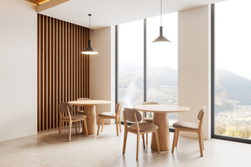 Beige cafe interior with chairs and tables in row, dining space near window