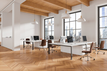 Modern office interior with pc computers on tables in row, panoramic window