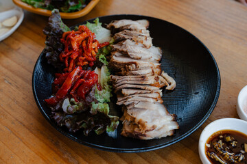 Korean food Plate of Sliced Pork with Vegetables and Sauces