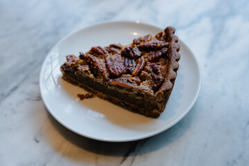 Slice of Pecan Pie on White Plate
