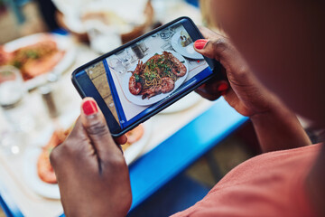 Food, smartphone and hands at restaurant for photography, social media or status update from behind. Woman, influencer screen and meal at cafeteria for blog, post or online review for followers