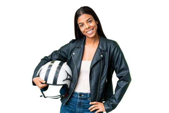 Young African American woman with a motorcycle helmet over isolated chroma key background posing with arms at hip and smiling