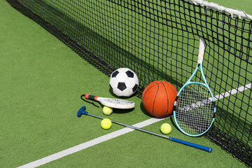 A group of sports equipment on background including tennis, basketball, and soccer on a background with copy space