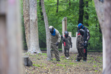 children playing paintball in the forest
