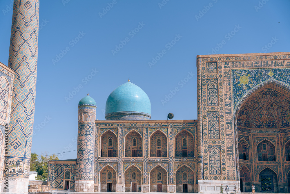 Wall mural a blue dome sits atop a large building with a blue tower in the background. the building is ornate a