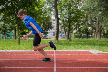The teenager starts at the stadium.
