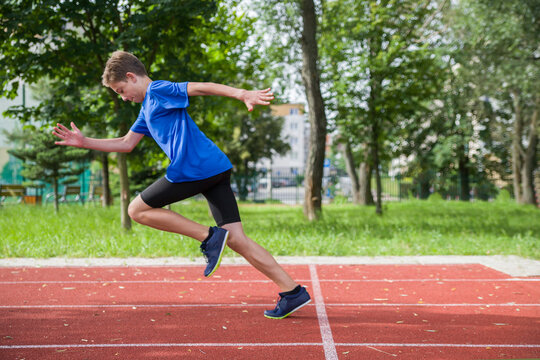 The teenager starts at the stadium.
