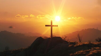 Sunrise over mountains with a cross in the foreground