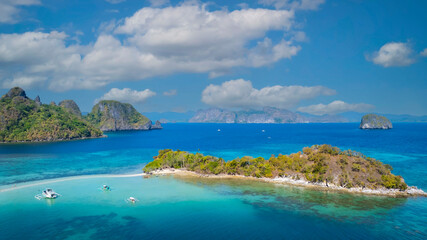 Aerail view of  tropical exotic island sand bar separating sea in two with turquoise  in El Nido, Palawan, Philippines.