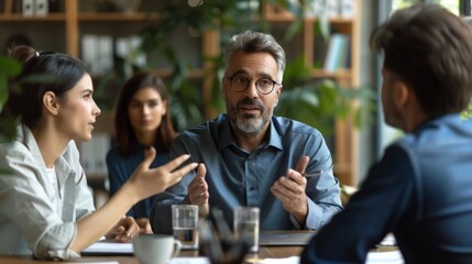 staff meeting in office at table, Caucasian male manager discussing with staff at table in office