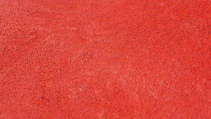 Top angle view of red tennis court texture. Red tennis field background. 
