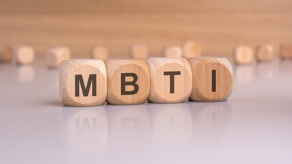 wooden blocks with text mbti, brawn background