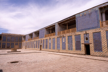 A large building with blue and white tiles on the walls. The building is empty and has a lot of windows