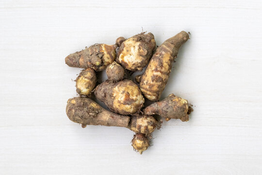 Fresh taro root or kochur mukhi isolated on light white background. Top view.