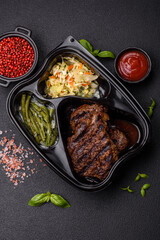 Fresh juicy delicious beef steak on a dark background