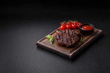 Fresh juicy delicious beef steak on a dark background