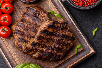 Fresh juicy delicious beef steak on a dark background