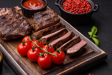 Fresh juicy delicious beef steak on a dark background
