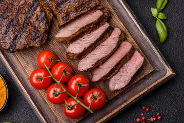 Fresh juicy delicious beef steak on a dark background