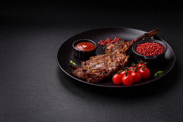 Juicy beef tomahawk steak on the bone baked on the grill