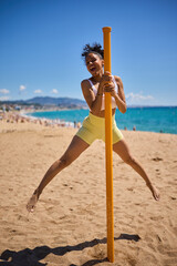 Young athletic latin woman on the beach doing sports