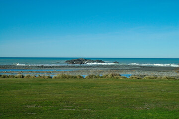 Strolling on the beach under the winter sun in New Zealand