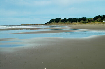 Strolling on the beach under the winter sun in New Zealand