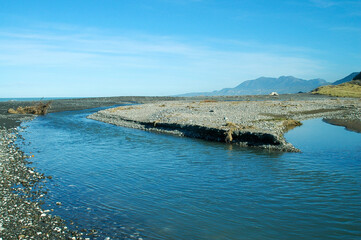 Strolling on the beach under the winter sun in New Zealand