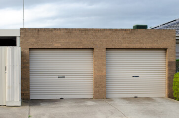 A sturdy and traditional garage of an Australian suburban house with two adjacent closed garage...