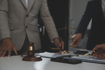 Judge gavel with Justice lawyers having team meeting at law firm background. Concepts of Law and Legal services.