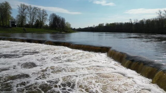 Flying along waterfall on the Venta River, Kuldiga, Latvia and Vimba (Vimba vimba) fish jumping over