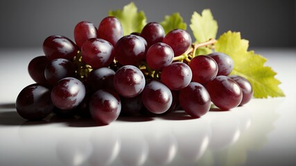 Fototapeta premium bunch of grapes on white table and plain background with dramatic lighting
