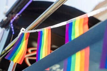 Rainbow flags hang above a tent selling symbols.