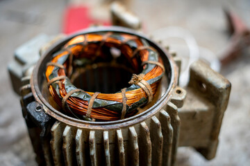 Inside of a disassembled machine containing a round copper coil