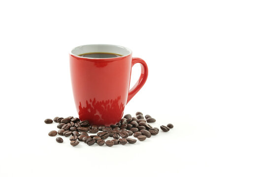 Red cup of coffee with roasted coffee beans isolated on white background with copy space
