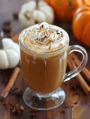 orange pumpkin spice latte coffee drink and cinnamon sprinkles