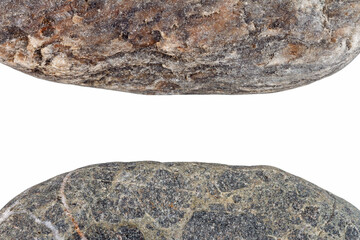 Edges of two pebbles isolated on white background