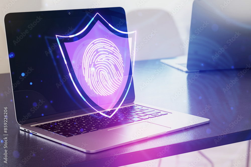 Poster laptop with a holographic fingerprint shield, on a desk with a bokeh background, symbolizing cyberse